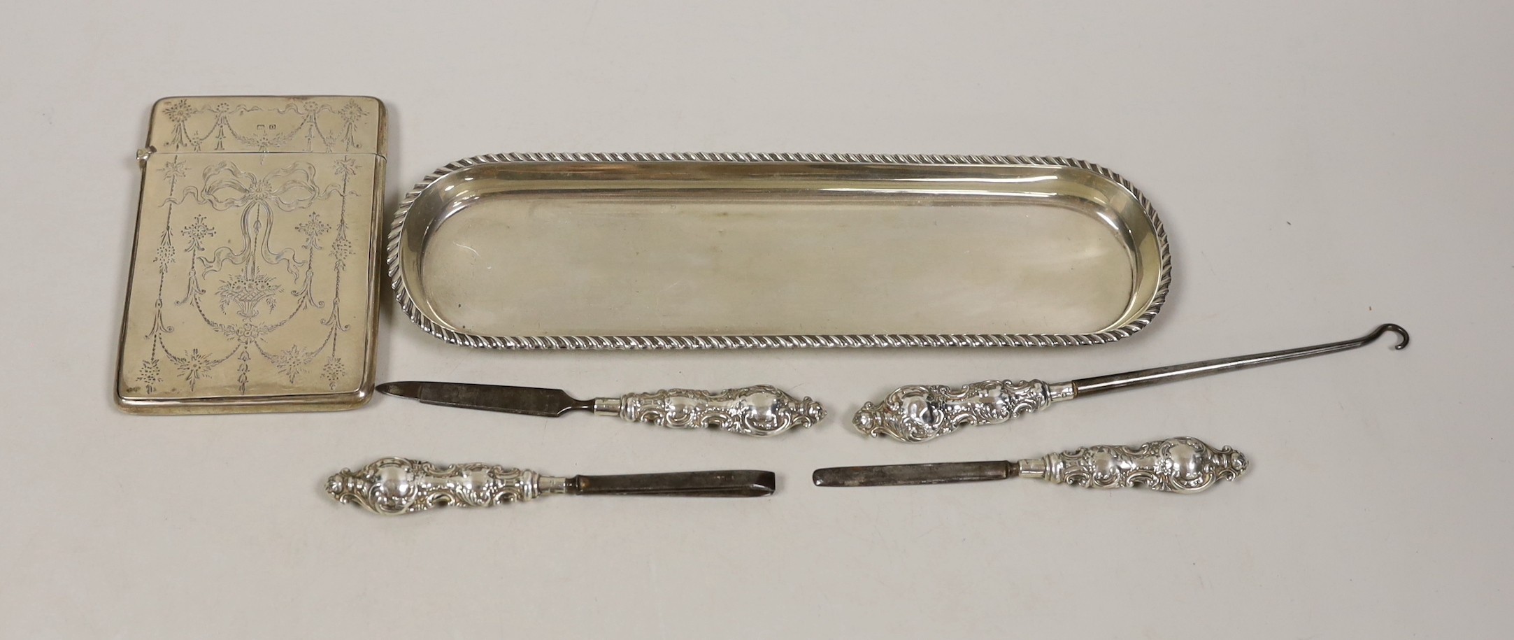 A George V engraved silver card case, by Crisford & Norris, a silver pen tray and four manicure tools.